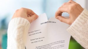 Hands tearing a divorce document in half