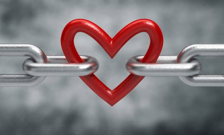 image of a heart connected to a chain, concept of love, codependency, and attachment trauma