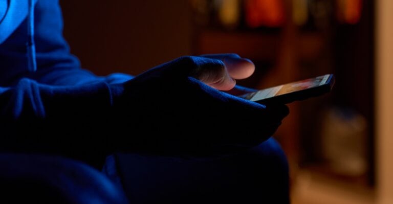 using smartphone in the dark room, concept of mobile use and porn consumption
