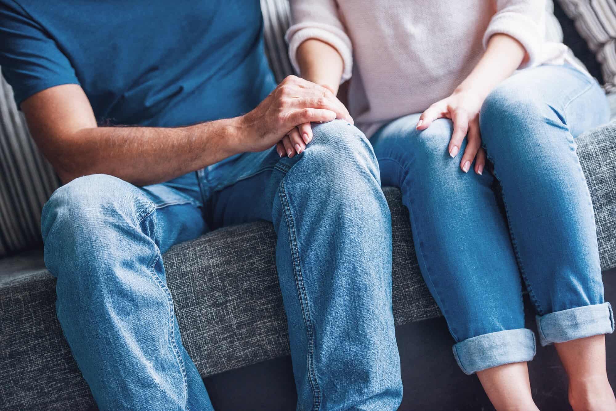 couple holding hands during therapy session