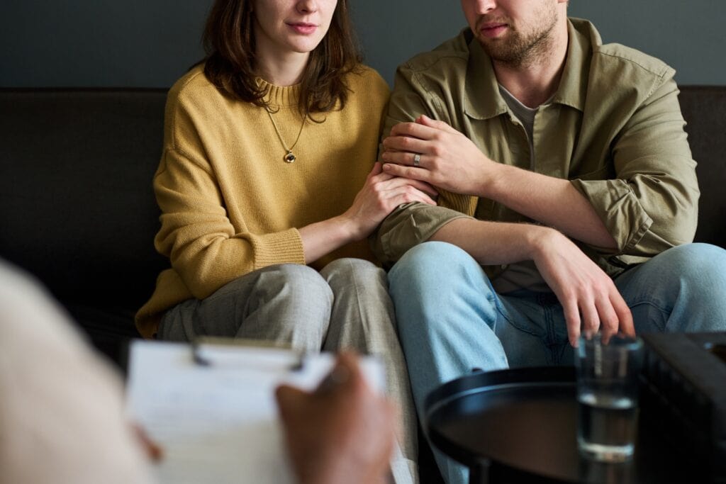 couple sitting beside each other during couple counseling session, therapy
